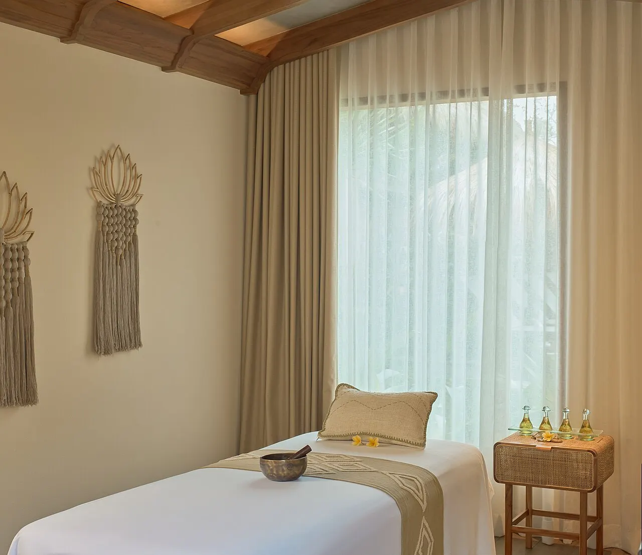 A daylit treatment room with a made-up treatment table